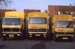 Three yellow Peter vans parked next to each other