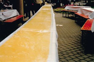 A very long rolled-out pasta dough on a table