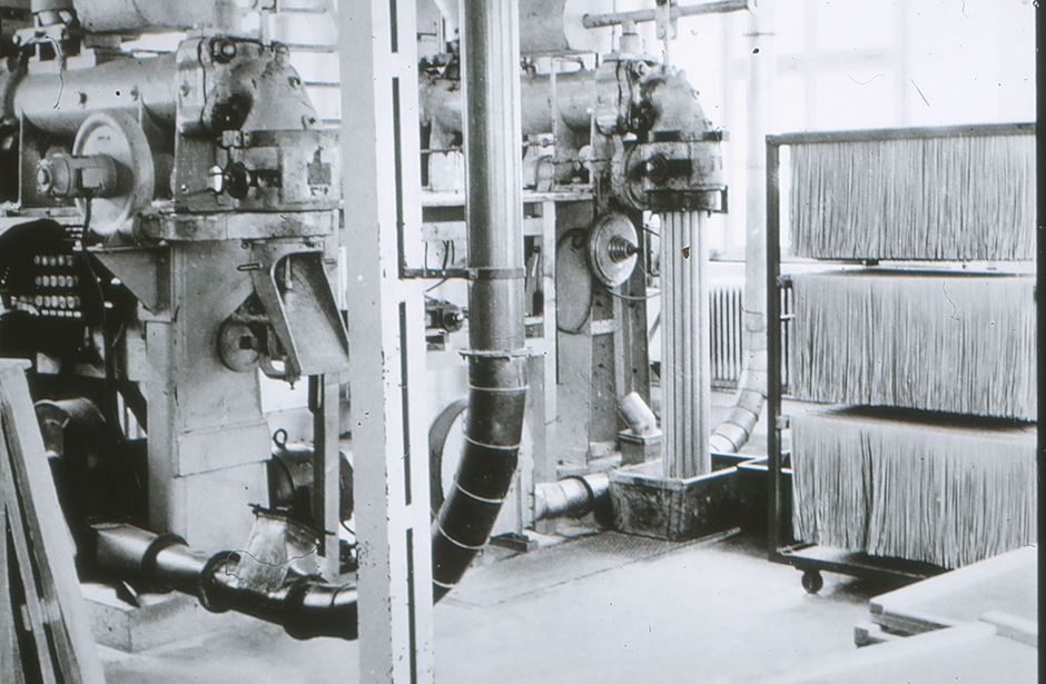 Industrial piping and valves in a production plant with filters on the right-hand side
